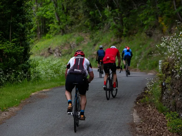 Cyclists climbing a quiet road near Labastide-Esparbairenque in the Montagne Noire